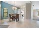 Open dining area featuring modern chandelier and an accent wall near kitchen and living spaces at 9144 Bassett Ln, New Port Richey, FL 34655