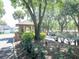 Welcoming entrance to a residential community with a charming guardhouse surrounded by mature trees and lush landscaping at 9144 Bassett Ln, New Port Richey, FL 34655