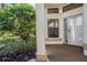 Inviting front entrance features a covered porch and manicured landscaping at 9144 Bassett Ln, New Port Richey, FL 34655
