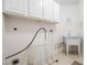 Functional laundry room with a sink and storage cabinets at 9144 Bassett Ln, New Port Richey, FL 34655