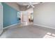 Spacious living area with high ceilings, large windows, light-colored tile flooring, and a view into the dining room at 9144 Bassett Ln, New Port Richey, FL 34655