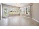 Bright sun room with tile flooring, large windows, and access to the outside at 9144 Bassett Ln, New Port Richey, FL 34655