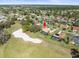 Aerial view of a home with golf course frontage and a screened pool at 9630 Southern Belle Dr, Weeki Wachee, FL 34613