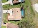 Birds eye view of a home with a screened in pool, patio, lush lawn, and attractive roof at 9630 Southern Belle Dr, Weeki Wachee, FL 34613