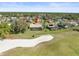 Beautiful aerial view of homes surrounding a golf course and sand trap in a lovely neighborhood at 9630 Southern Belle Dr, Weeki Wachee, FL 34613