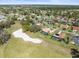 Panoramic aerial shot showcasing a golf course winding through a neighborhood of well-maintained homes at 9630 Southern Belle Dr, Weeki Wachee, FL 34613