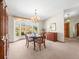 Cozy dining room featuring a chandelier and views of the outdoors at 9630 Southern Belle Dr, Weeki Wachee, FL 34613