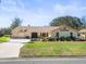 Attractive single story home featuring a well-manicured lawn and a spacious driveway at 9630 Southern Belle Dr, Weeki Wachee, FL 34613