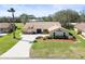 Inviting front exterior with mature landscaping and a concrete driveway at 9630 Southern Belle Dr, Weeki Wachee, FL 34613