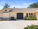 Charming front exterior featuring double front doors and manicured landscaping at 9630 Southern Belle Dr, Weeki Wachee, FL 34613