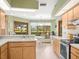 Bright kitchen with tile flooring, skylight and breakfast nook with backyard views at 9630 Southern Belle Dr, Weeki Wachee, FL 34613