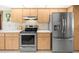 Well-lit kitchen featuring stainless steel appliances and wooden cabinets at 9630 Southern Belle Dr, Weeki Wachee, FL 34613