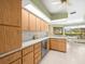 Bright kitchen with wooden cabinets, skylight and stainless steel appliances at 9630 Southern Belle Dr, Weeki Wachee, FL 34613
