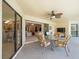 Inviting outdoor lanai with comfortable seating and a view through sliding doors to the home interior at 9630 Southern Belle Dr, Weeki Wachee, FL 34613