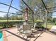 Outdoor lanai featuring an umbrella covered table and chairs at 9630 Southern Belle Dr, Weeki Wachee, FL 34613