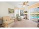 Cozy living room features plush armchairs and view to screened pool at 9630 Southern Belle Dr, Weeki Wachee, FL 34613