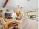 Comfortable living room with stone fireplace and sliding door to the patio at 9630 Southern Belle Dr, Weeki Wachee, FL 34613