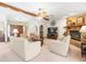 Bright living room with exposed beam and stone fireplace, great for entertaining at 9630 Southern Belle Dr, Weeki Wachee, FL 34613