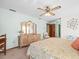 Relaxing bedroom showcases a floral bedspread, light-colored walls, and dresser at 9630 Southern Belle Dr, Weeki Wachee, FL 34613