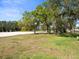 Residential area with a sand trap surrounded by trees and green space at 9630 Southern Belle Dr, Weeki Wachee, FL 34613