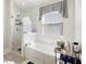 Bright bathroom featuring a glass shower and a tub under a window with natural light and modern fixtures at 11023 Silver Dancer Dr, Riverview, FL 33579