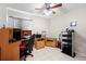 A bedroom featuring a desk, gaming chair, and a keyboard at 11023 Silver Dancer Dr, Riverview, FL 33579