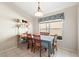 Cozy dining room features a large window and a table set for four, perfect for intimate meals at 11023 Silver Dancer Dr, Riverview, FL 33579