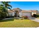 Inviting single-Gathering home with lush landscaping and a two-car garage, set against a clear blue sky at 11023 Silver Dancer Dr, Riverview, FL 33579