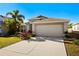 Charming single-story home featuring a well-manicured lawn and a two-car garage at 11023 Silver Dancer Dr, Riverview, FL 33579