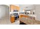 Modern kitchen features stainless steel appliances, granite countertops, and seamless flow to the living room at 11023 Silver Dancer Dr, Riverview, FL 33579