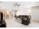 Spacious living room featuring an open layout, tile flooring, and seamless connection to the kitchen at 11023 Silver Dancer Dr, Riverview, FL 33579