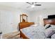 Comfortable bedroom features wood-look floors, a ceiling fan, and a well-coordinated furniture set at 11023 Silver Dancer Dr, Riverview, FL 33579