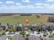 Aerial view of homes in a serene, sprawling community with a big field on the horizon at 11895 Crestridge Loop, New Port Richey, FL 34655