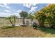 Landscaped backyard with a white fence, manicured lawn, and lush tropical plants offering privacy at 11895 Crestridge Loop, New Port Richey, FL 34655