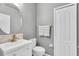 Bright bathroom featuring a modern vanity, oval mirror and neutral color palette at 11895 Crestridge Loop, New Port Richey, FL 34655