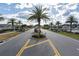 Gated community entrance with lush landscaping, palm trees, and well-maintained streets in a suburban neighborhood at 11895 Crestridge Loop, New Port Richey, FL 34655