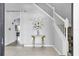 Open foyer with a staircase, tiled floor, and decorative table at 11895 Crestridge Loop, New Port Richey, FL 34655