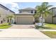 Charming two-story home with lush landscaping, a brick driveway and a two car garage at 11895 Crestridge Loop, New Port Richey, FL 34655