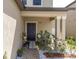 Inviting front porch with potted plants, a bench, and a stylish door at 11895 Crestridge Loop, New Port Richey, FL 34655