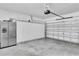 Spacious two car garage features lots of built in storage and stainless steel refrigerator at 11895 Crestridge Loop, New Port Richey, FL 34655