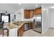 Well-equipped kitchen featuring stainless steel appliances, granite countertops, and ample wood cabinetry at 11895 Crestridge Loop, New Port Richey, FL 34655