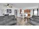 Spacious living area showcasing an open layout to the kitchen with cozy seating and modern fixtures at 11895 Crestridge Loop, New Port Richey, FL 34655