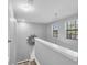 Stairway landing with neutral paint and trim, enhanced by natural light from nearby windows at 11895 Crestridge Loop, New Port Richey, FL 34655