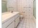 Bright bathroom featuring a vanity, toilet, and shower-tub combination at 1223 Queen Anne Dr # B, Palm Harbor, FL 34684