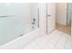 Tiled bathroom with a shower-tub combination and sliding glass door at 1223 Queen Anne Dr # B, Palm Harbor, FL 34684
