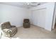 Bedroom featuring two recliner chairs and a closet at 1223 Queen Anne Dr # B, Palm Harbor, FL 34684