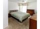 Cozy bedroom with carpet and wooden furniture, bright natural light at 1223 Queen Anne Dr # B, Palm Harbor, FL 34684