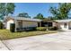 Charming single-story home featuring a well-maintained lawn and neutral-toned exterior at 1223 Queen Anne Dr # B, Palm Harbor, FL 34684