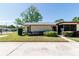 Well-kept single-story home showcasing a manicured lawn and a welcoming entrance at 1223 Queen Anne Dr # B, Palm Harbor, FL 34684