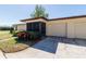 Desirable home features a two-car garage, a screened entry, and manicured bushes enhancing curb appeal at 1223 Queen Anne Dr # B, Palm Harbor, FL 34684